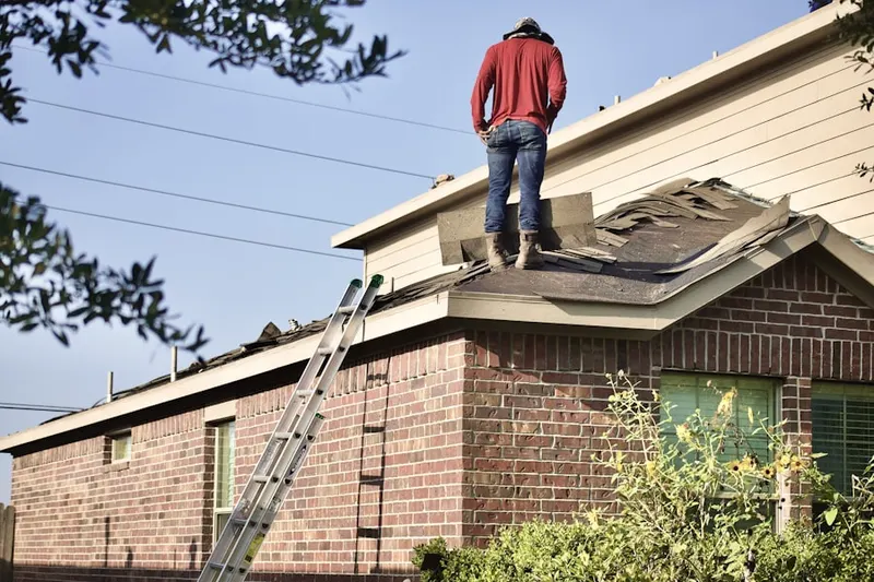 Professional roofer working on a residential roof in Dilworthtown Woods